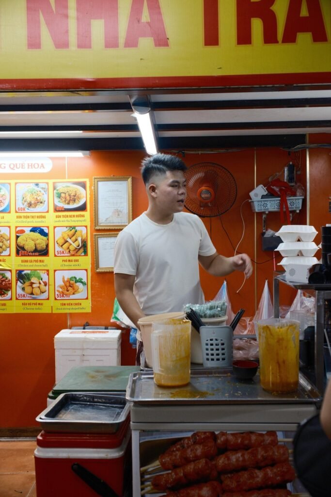 Kraam met gegrilde nem nướng in Hanoi, met de kok erachter